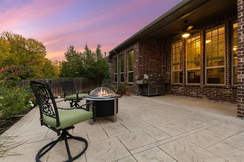 a view of a backyard with sitting area
