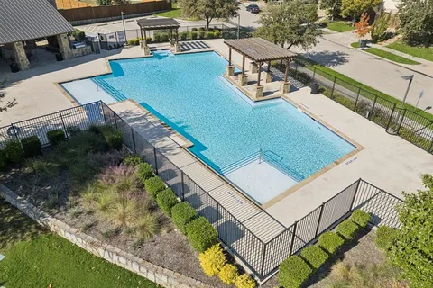 an aerial view of a residential houses with outdoor space