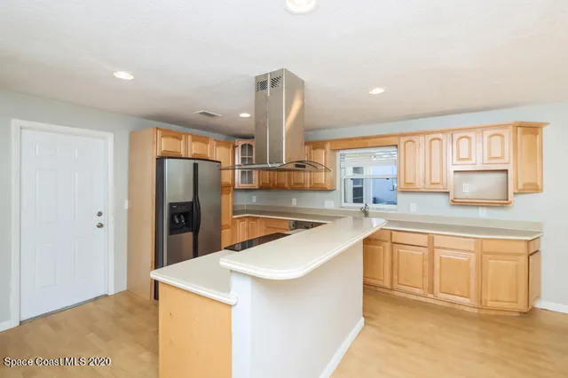 a kitchen with stainless steel appliances a refrigerator sink and stove