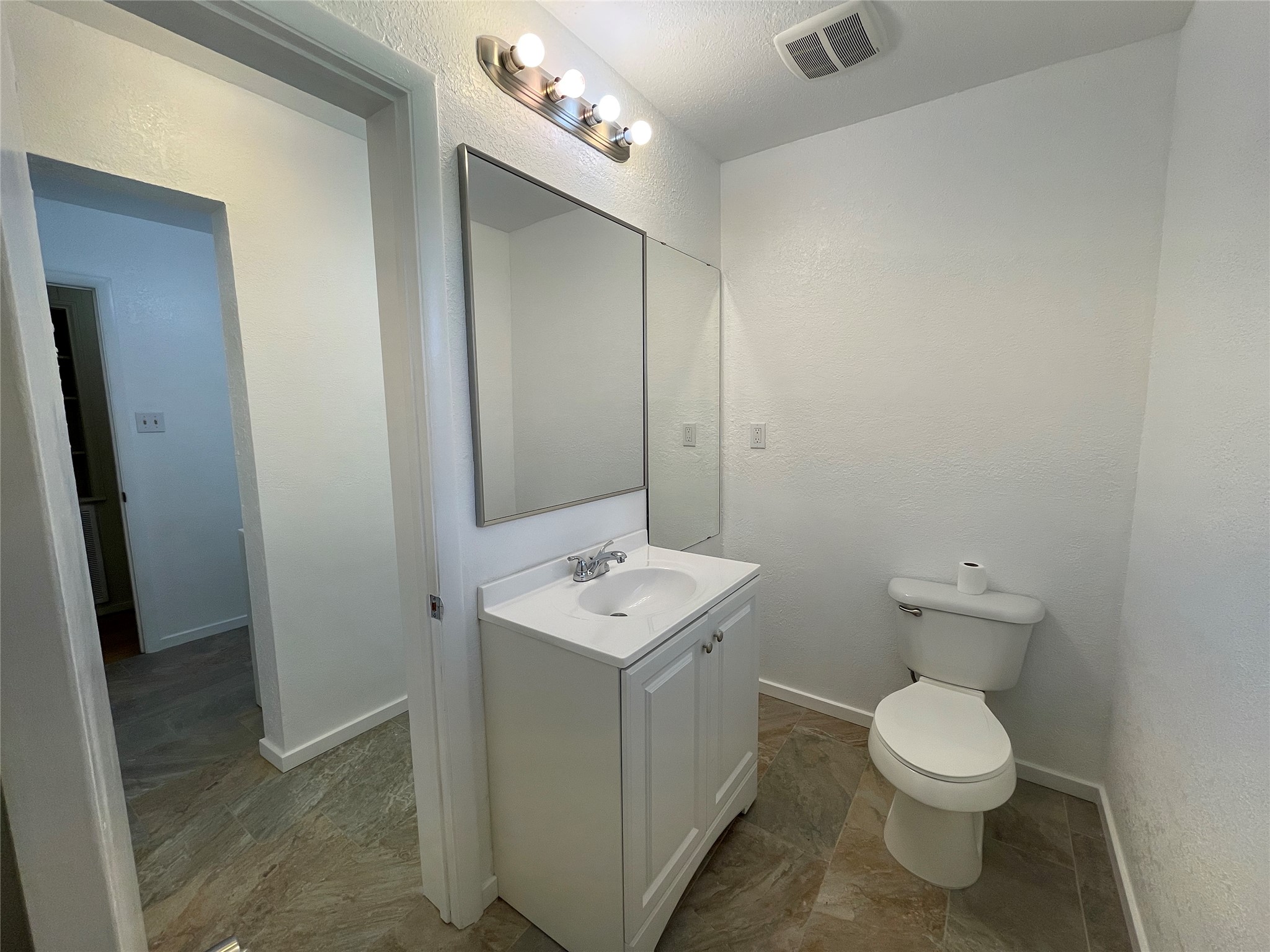 19439 Keenan Cut Off Road Montgomery, TX 77316 - Photo 33 of 39 a bathroom with a toilet sink and mirror