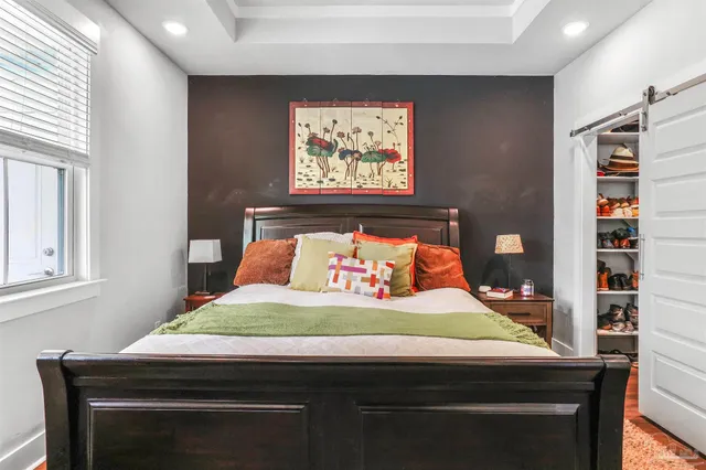 a room with a bed and a bookshelf