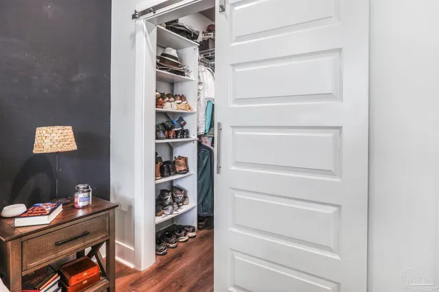 a view of walk in closet with clothes and shoes
