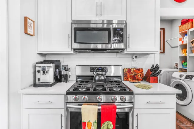 a kitchen with stainless steel appliances a stove a microwave and cabinets