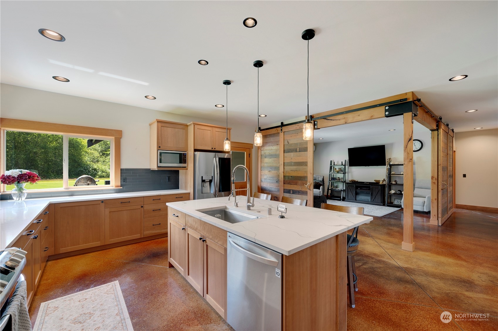 1680 Butler Creek Road Sedro-Woolley, WA 98284 - Photo 11 of 40 a kitchen with a sink a counter top space stainless steel appliances a flat screen tv and a window