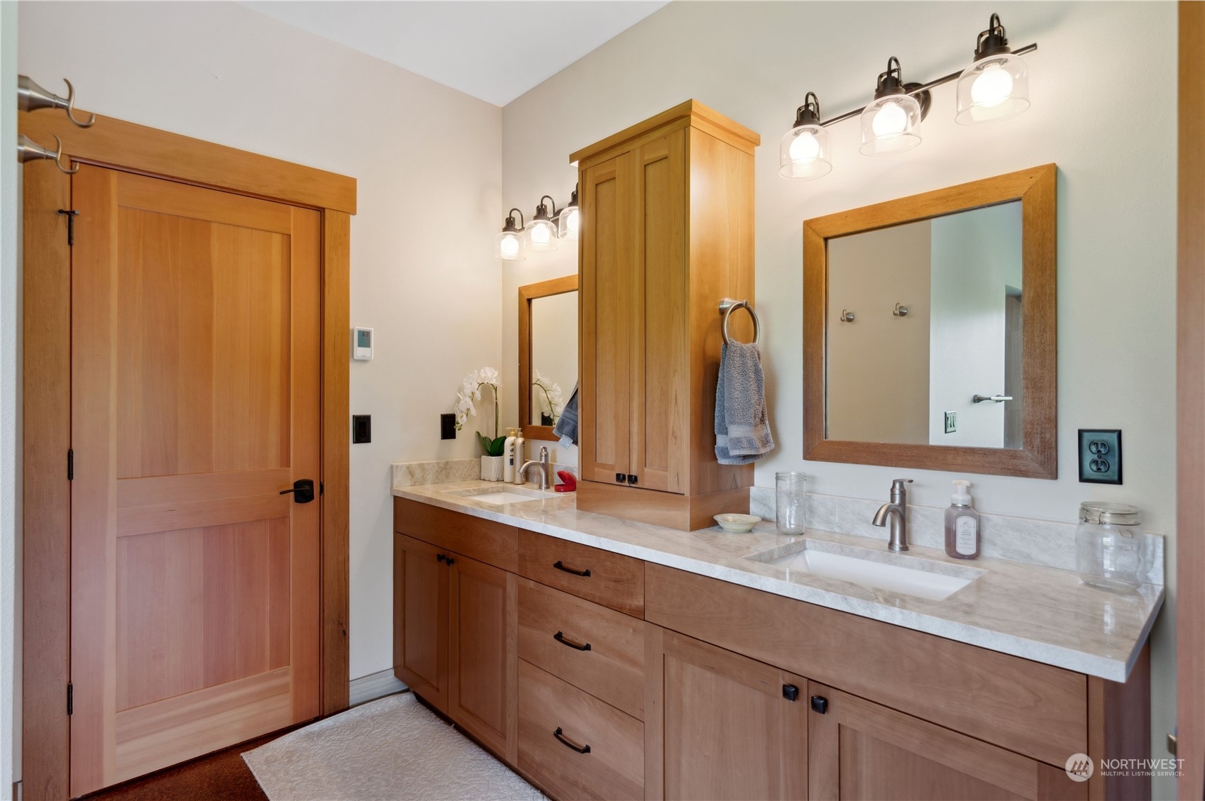 1680 Butler Creek Road Sedro-Woolley, WA 98284 - Photo 24 of 40 a bathroom with a double vanity sink and a mirror