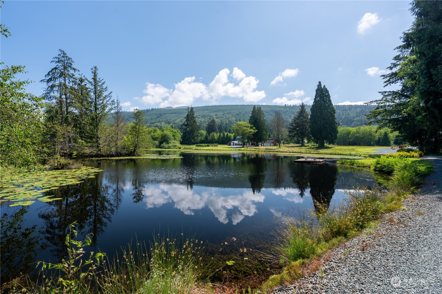 1680 Butler Creek Road Sedro-Woolley, WA 98284 - Photo 3 of 40 a view of a lake with a yard and a fountain