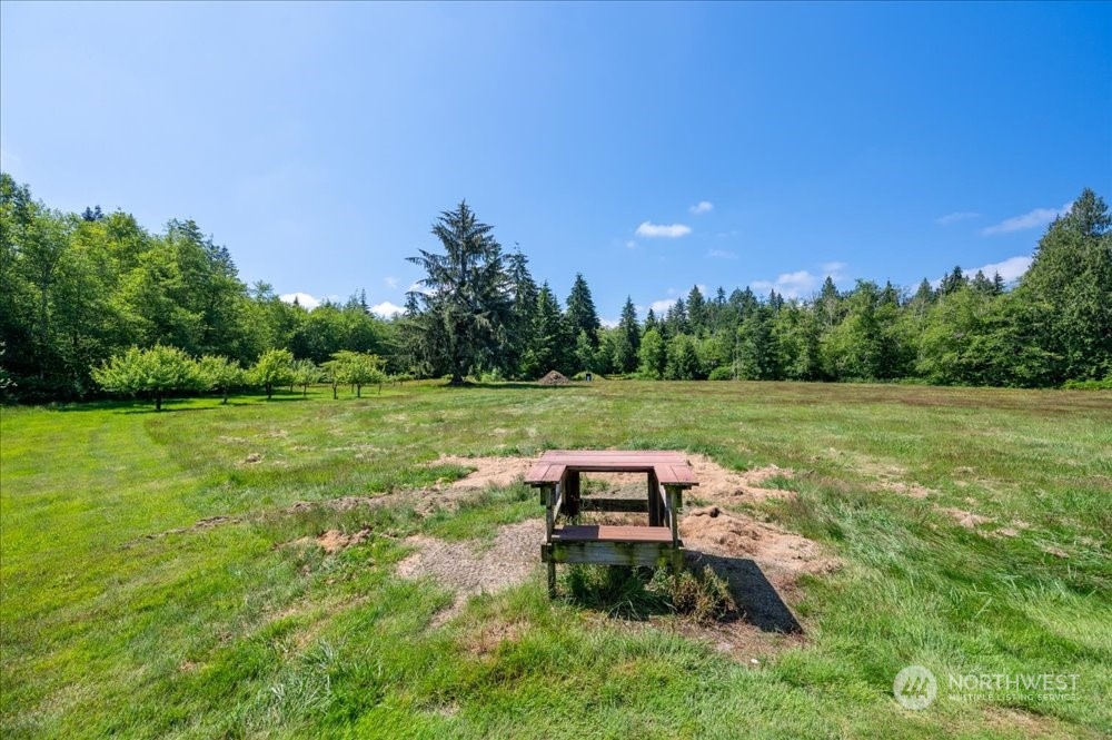 1680 Butler Creek Road Sedro-Woolley, WA 98284 - Photo 39 of 40 a wooden bench sitting in the middle of a garden