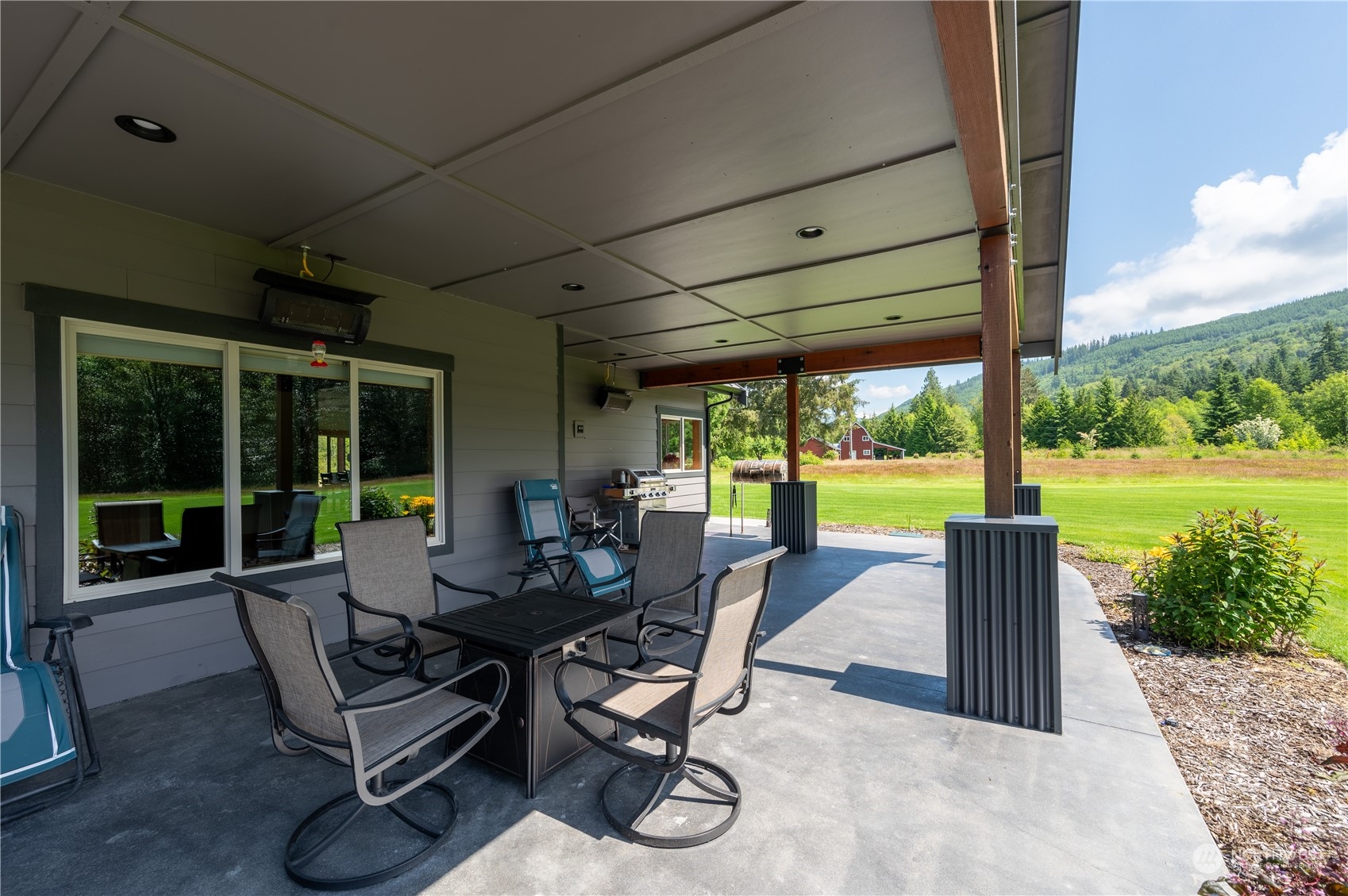 1680 Butler Creek Road Sedro-Woolley, WA 98284 - Photo 5 of 40 a view of a patio with table and chairs