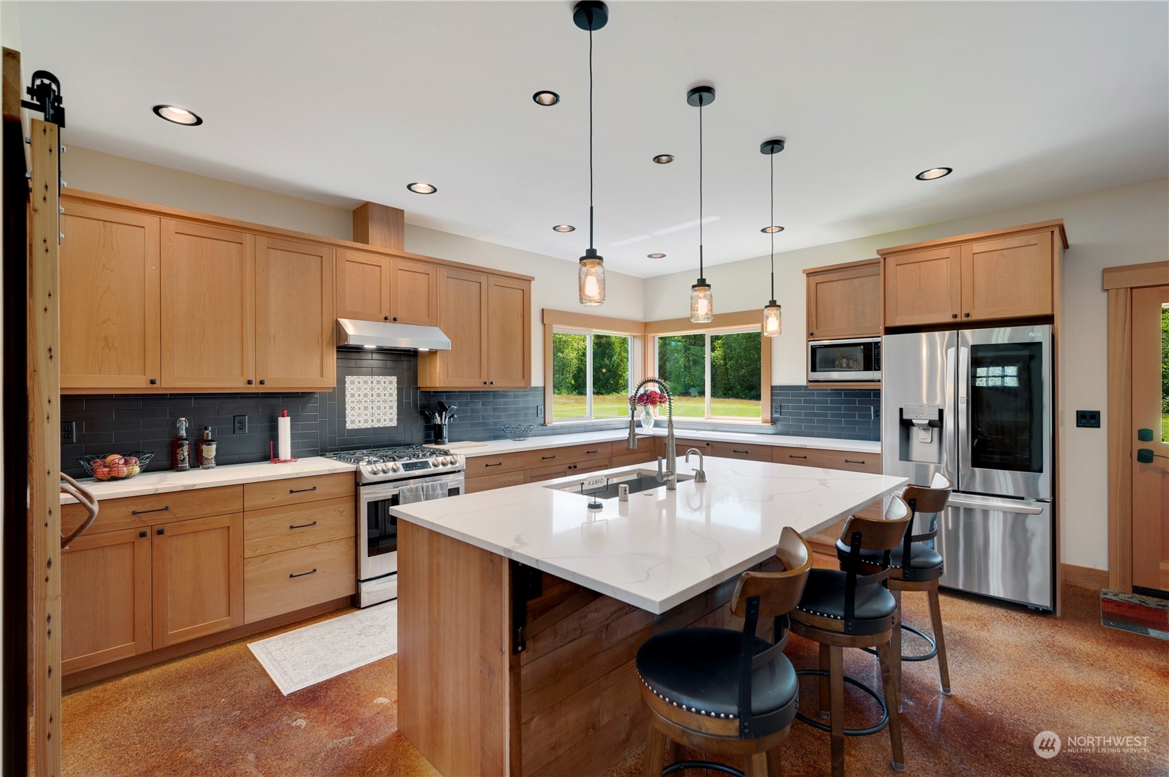 1680 Butler Creek Road Sedro-Woolley, WA 98284 - Photo 10 of 40 a kitchen with a dining table chairs sink and cabinets