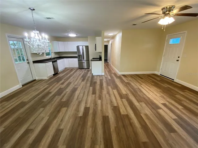 a view of a livingroom with a chandelier fan