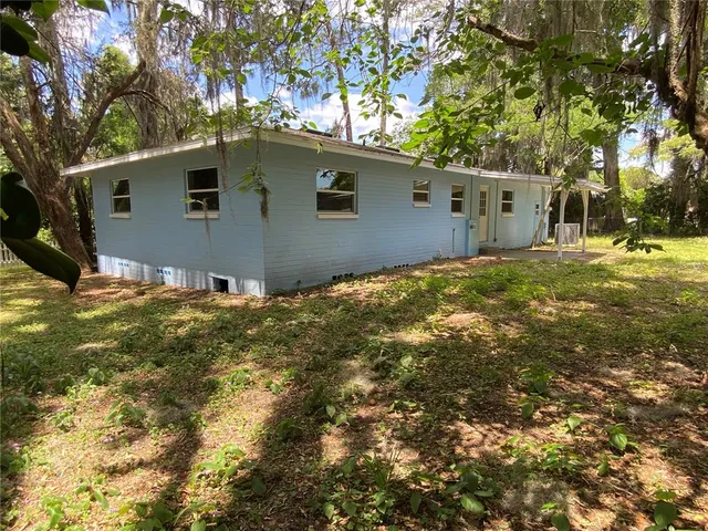 a view of a house with yard and a tree