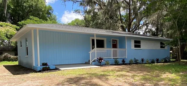 a view of a house with a yard
