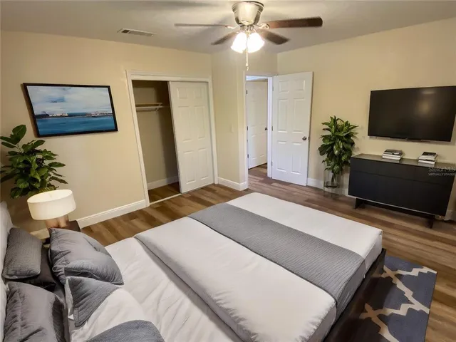 a bedroom with a bed and a flat screen tv