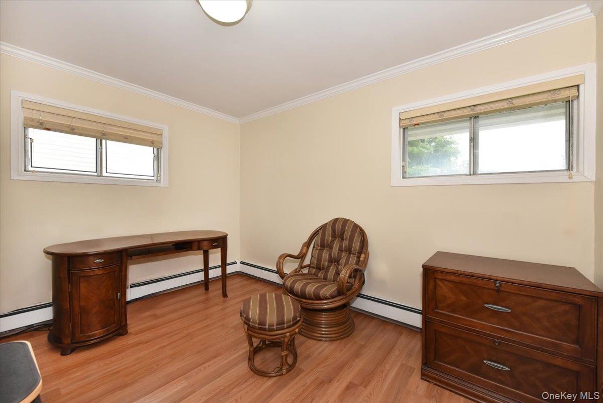 307 Blacksmith Road Levittown, NY 11756 - Photo 17 of 27 a living room with furniture and a wooden floor