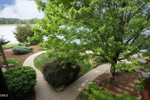 a view of a house with backyard sitting area and garden