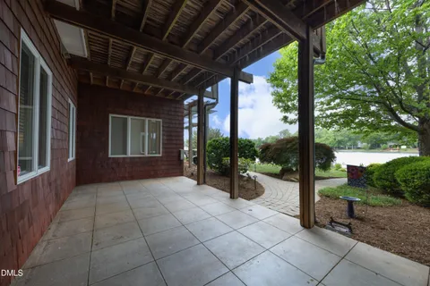 a view of a house with backyard sitting area and garden
