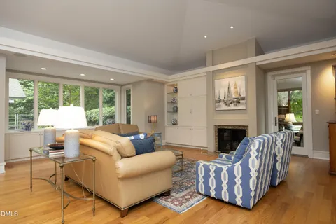 a living room with furniture and a floor to ceiling window