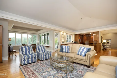 an aerial view of a house with a garden and lake view