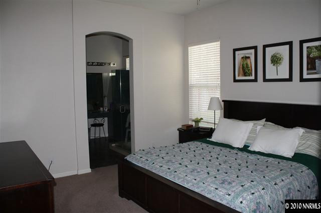10285 Grizzly Hill Court Reno, NV 89521 - Photo 5 of 13 a bedroom with a bed and wooden floor