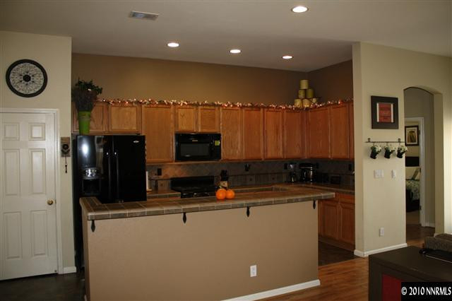 10285 Grizzly Hill Court Reno, NV 89521 - Photo 8 of 13 a kitchen with a sink a refrigerator and a stove top oven