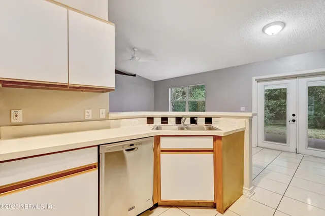 a kitchen with stainless steel appliances granite countertop a sink and cabinets