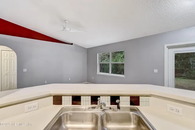 a bathroom with a tub sink and mirror