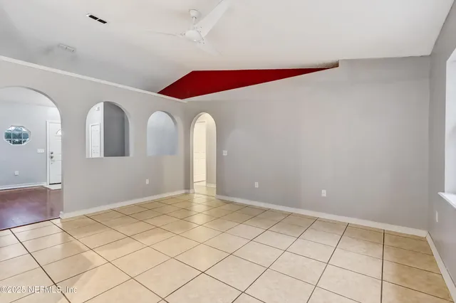 a view of a kitchen with kitchen island and natural light