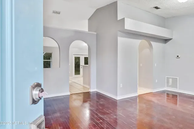 a view of livingroom and dining room with wooden floor