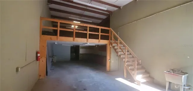 a view of staircase with white walls and a window