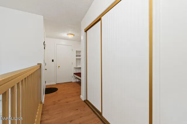 a view of a hallway with wooden floor