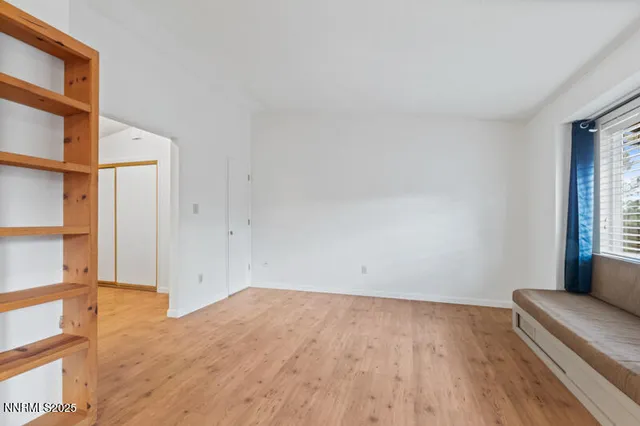 a view of room with window and wooden floor