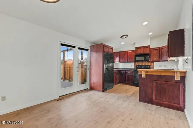 a kitchen with stainless steel appliances granite countertop a refrigerator and a sink