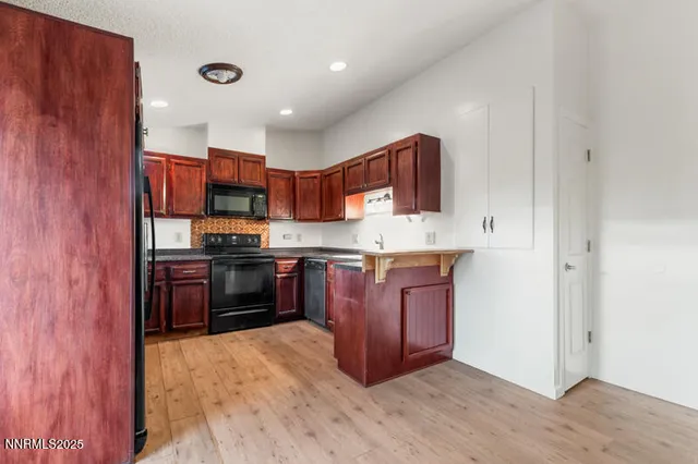 a kitchen with stainless steel appliances granite countertop a stove top oven a sink and dishwasher