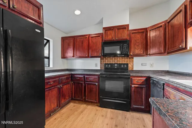 a kitchen with stainless steel appliances granite countertop a stove microwave and sink