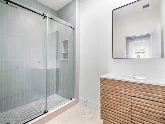 a bathroom with a shower and a sink