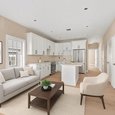 a living room with furniture and kitchen view