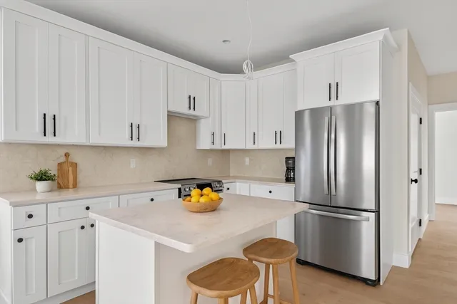 a kitchen with stainless steel appliances a refrigerator a stove a sink and cabinets