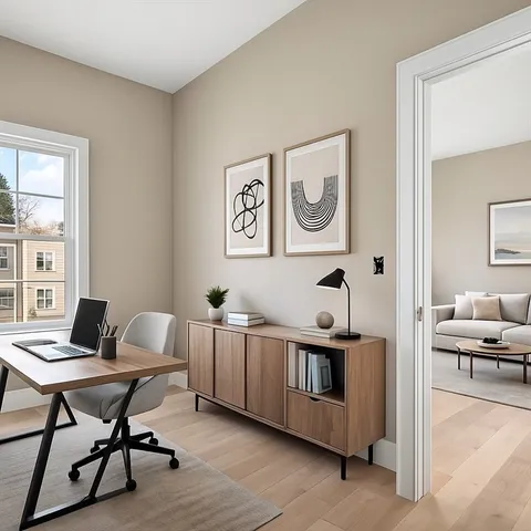 a view of a workspace with furniture and a window