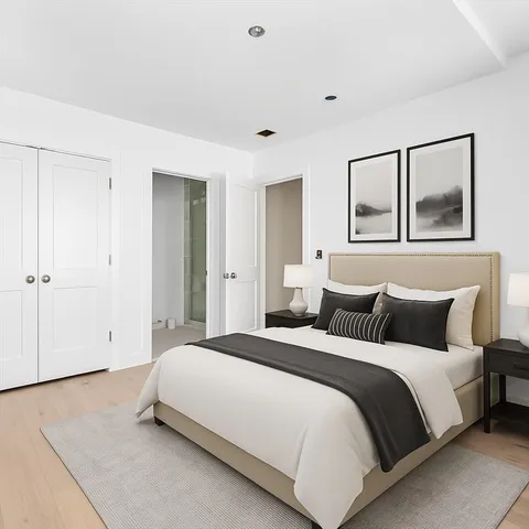 a bedroom with bed and night stand