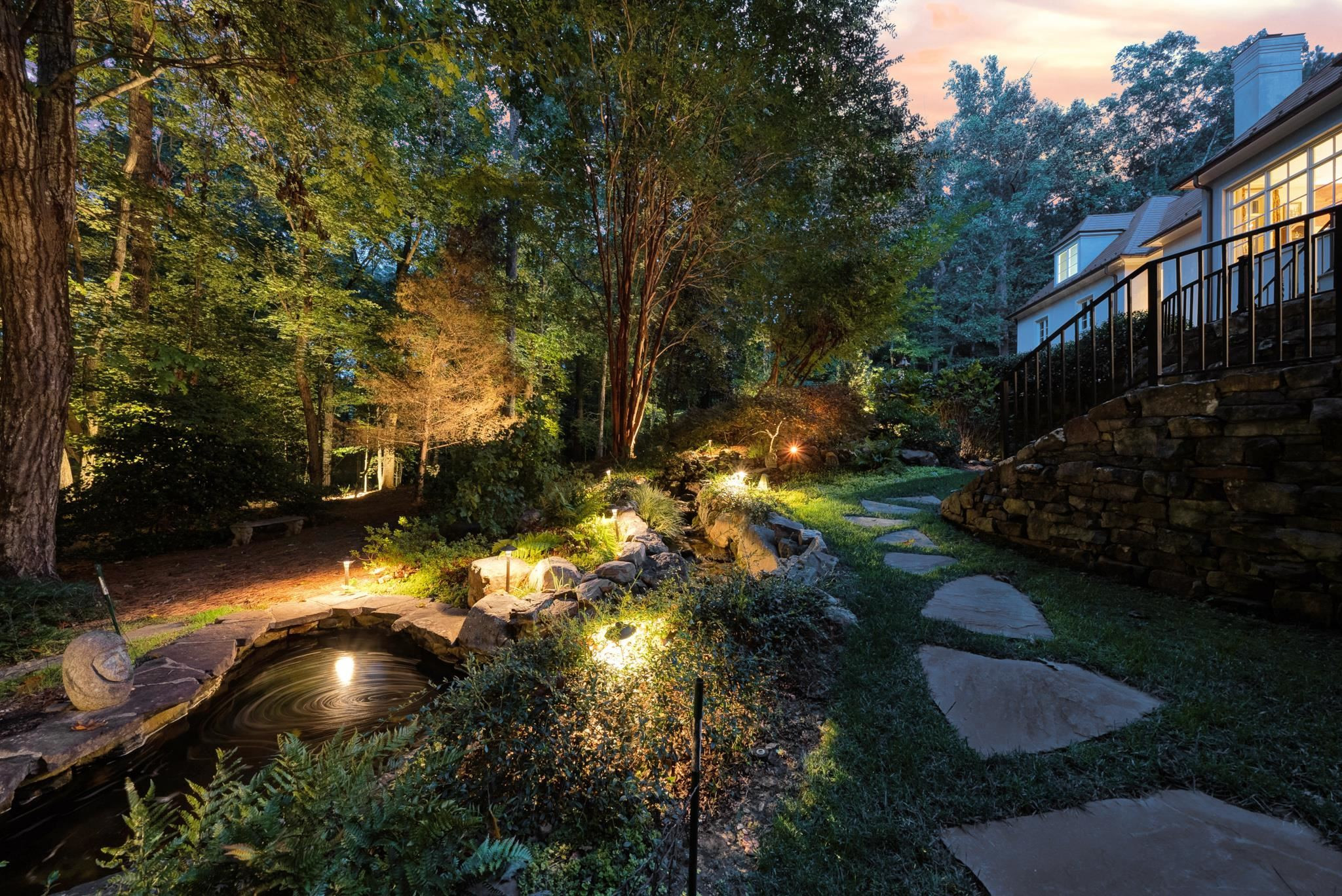 6036 Over Hadden Court Raleigh, NC 27614 - Photo 7 of 30 Gorgeous views of backyard at night with front and rear night scaping. Relax on the screened in back porch listening to the rock waterfall. Exterior Back Night