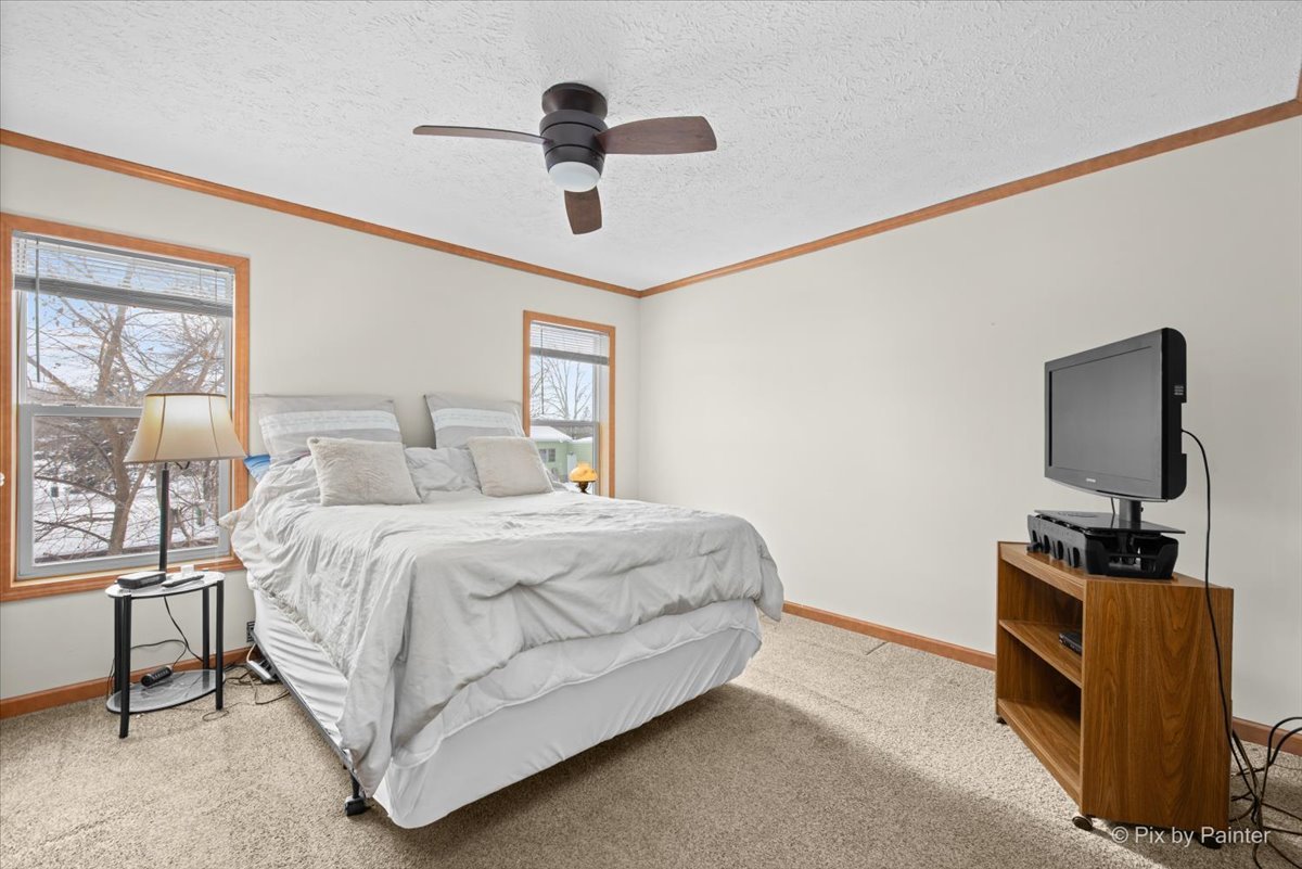 173 Northshore Road Elgin, IL 60123 - Photo 14 of 32 a bedroom with a bed and a flat tv screen on the dresser