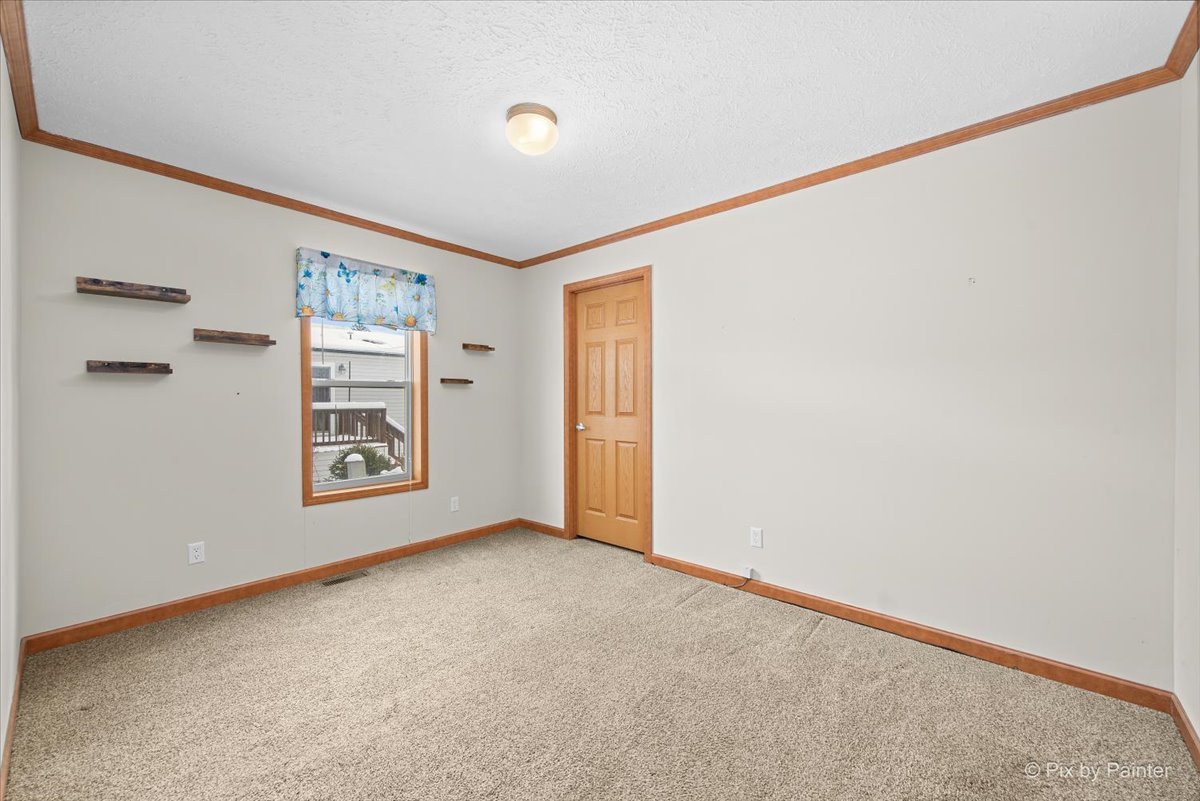 173 Northshore Road Elgin, IL 60123 - Photo 16 of 32 a view of an empty room with a window