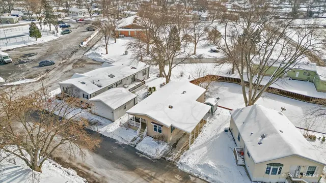 an aerial view of a residential houses with yard