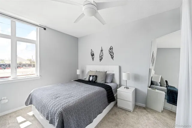 a bedroom with a bed and a large window