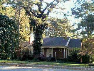 a house that has a tree in front of it