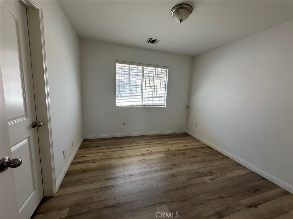 9532 Cortada Street El Monte, CA 91733 - Photo 6 of 10 an empty room with wooden floor and windows