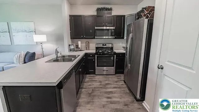 a living room with furniture and kitchen view