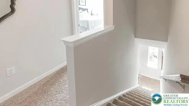 a bedroom with a bed and a lamp on dresser