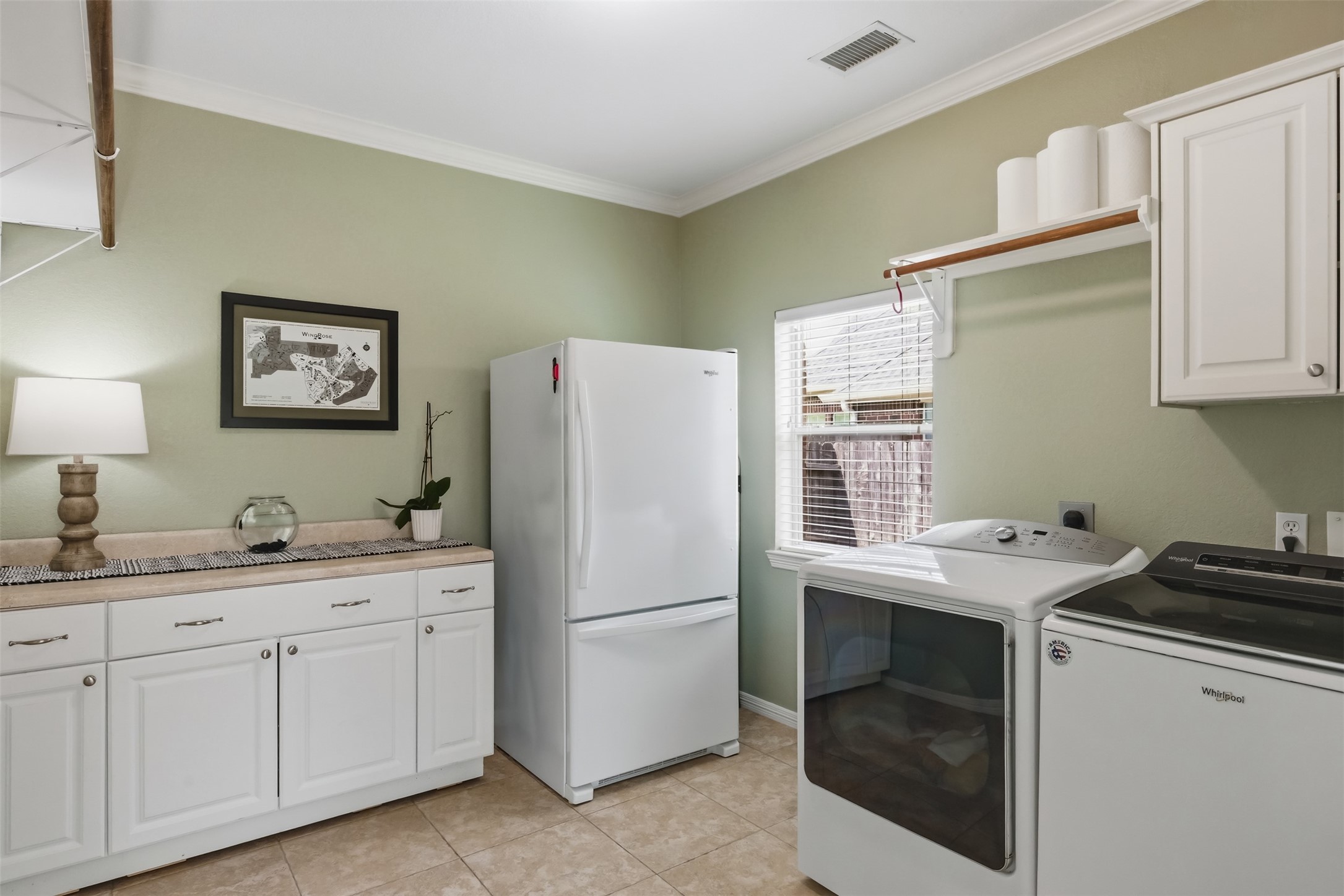 20722 Windrose Bend Drive Spring, TX 77379 - Photo 38 of 50 A peek into the ideal laundry room oasis with abundant cabinets, ample storage, a convenient folding counter, dual clothes rods, and space for an extra fridge; all designed to streamline your everyday life.