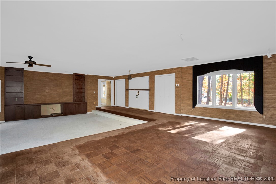 a view of an empty room with a fireplace and a large window